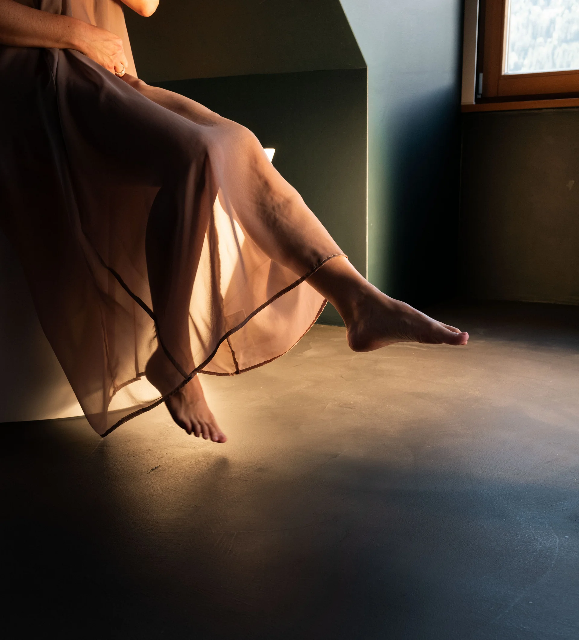 Doppelzimmer Classic Frau sitzt auf Fensterbank mit durchscheinendem Kleid und nackten Füßen